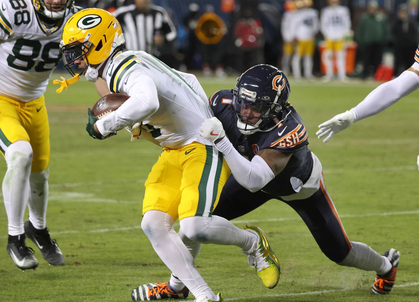 Chicago Bears cornerback Jaylon Johnson tries to bring down Green Bay Packers wide receiver Matthew Golden during their NFL Wild Card game Saturday, Jan. 10, 2026, at Soldier Field in Chicago.