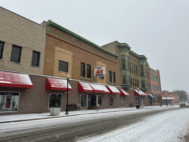 Snow sticks to the road outside of Debo Ace Hardware on Wednesday, Feb. 12, 2025 downtown Peru.