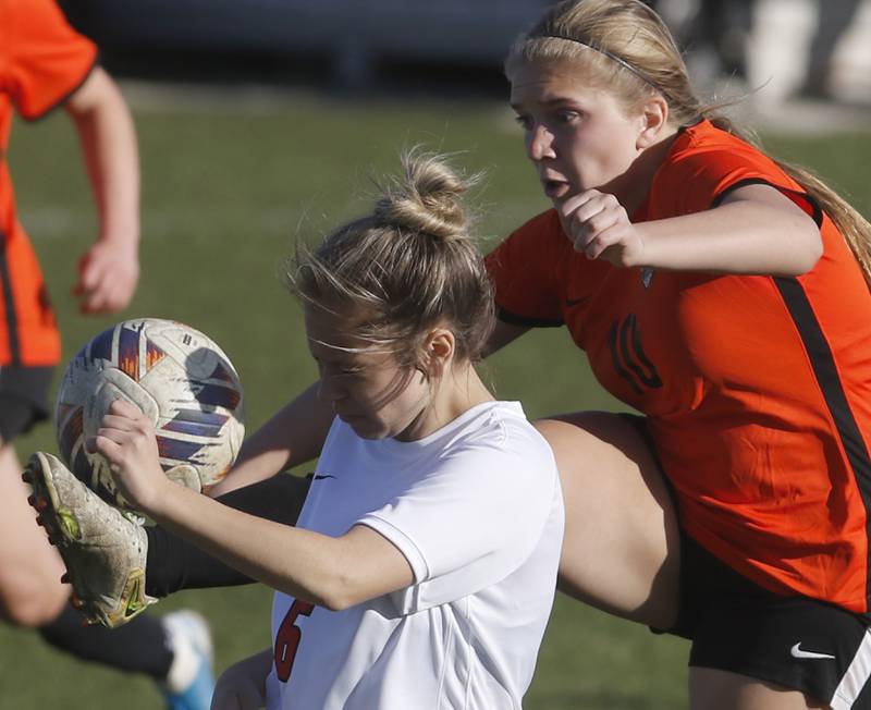 Crystal Lake Central's Brooklynn Carlson kicks the ball away from Huntley's Sophie Bator during a Fox Valley Conference soccer game on Tuesday, April 9, 2024, at Crystal Lake Central High School.