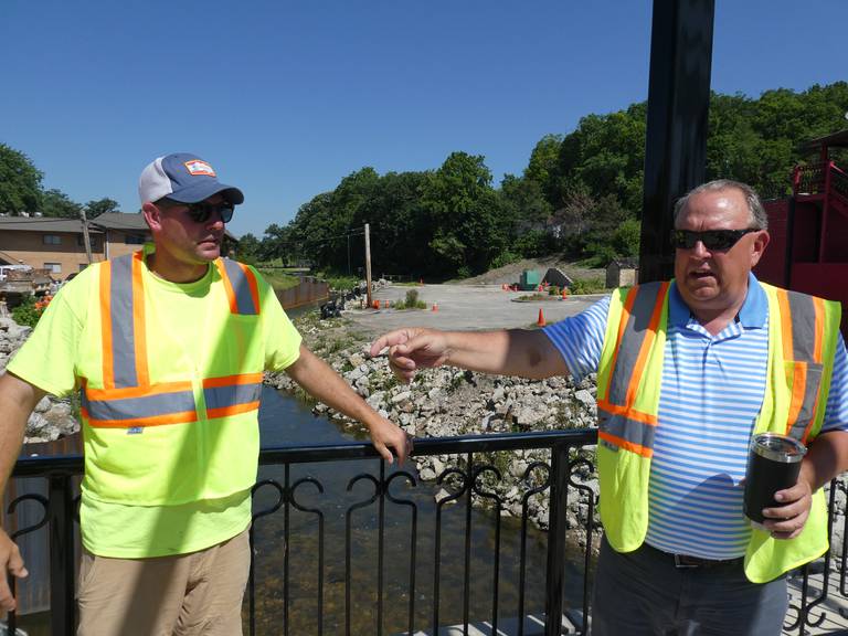 Martam Construction Superintendent T.J. Olson, left, and Algonquin Public Works Director Robert Mitchard discuss Tuesday, June 21, 2022, the ongoing reconstruction of Crystal Creek, which began with cofferdams being built between Towne Park and the Main Street bridge starting June 11.