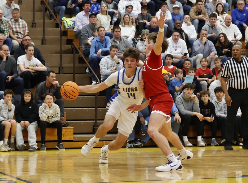 Lyons Township's Grant Smith (14) drives to the basket during a varsity basketball game between Hinsdale Central and Lyons Township high schools on Friday, Dec. 12, 2025 in La Grange.