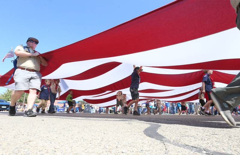 A large American Flag is carried by Cub Scouts and Boy Scouts down Main Street during the 52nd annual Homestead Festival parade on Saturday, Sept. 9, 2023 in Princeton.