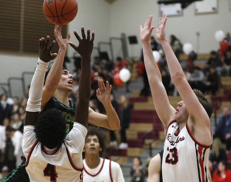 Crystal Lake South's AJ Demirov drives to the ball between Huntley's Jeffrey Cruickshank, (left) Omare Segarra, (center) and Ethan Blackmore during a Fox Valley Conference boys basketball game Tuesday, Feb.6, 2024, at Huntley High School.