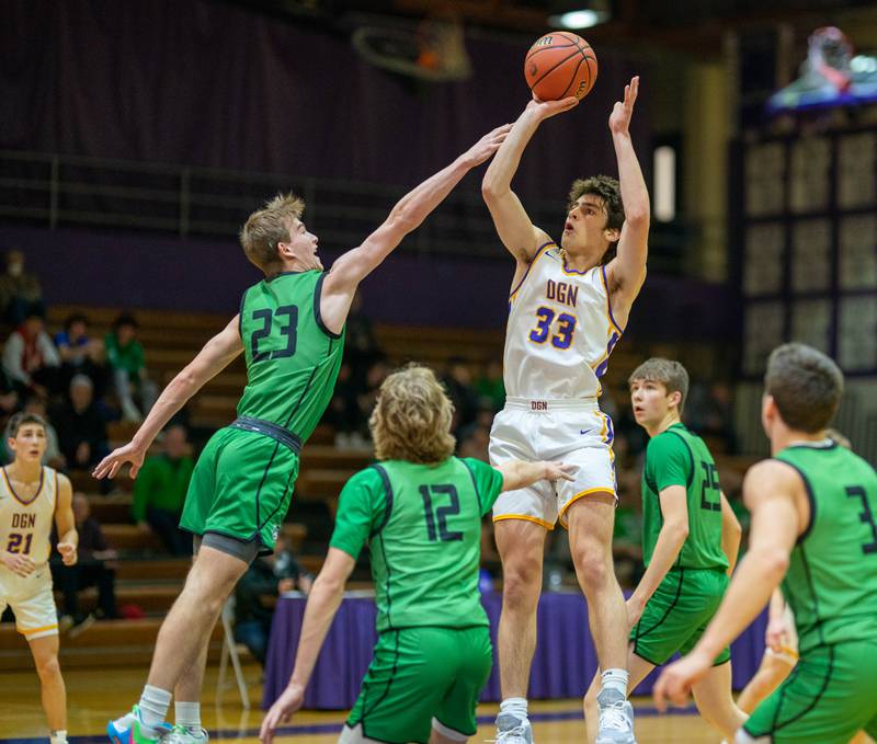 Downers Grove North's Finn Kramper (33) shoots the ball in the paint over York's Logan Rice (23) during a basketball game at Downers Grove North High School on Friday, Dec 9, 2022.