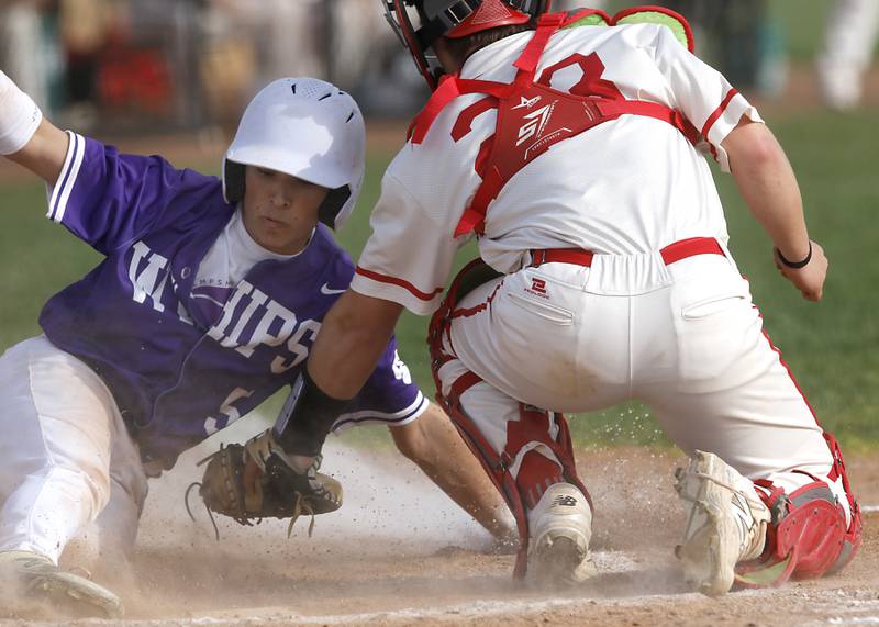 Hampshire's Jonathan Alexander slides into home plate as Huntley's Ashton Jones tries to apply the tag during a Fox Valley Conference baseball game on Monday, April 28, 2025, at Huntley High School.