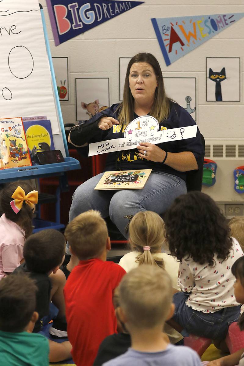 Kindergarten teacher Jeanette Lazare explains to her students hoe they will make their first day of kindergarten crown during the first day of school on Tuesday, Aug. 12, 2025, at District 300's Westfield Community School in Algonquin.