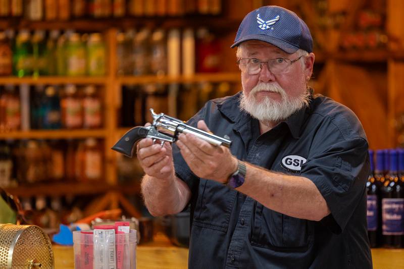 Glenn Pratt shows off gun to be raffled off at 'Guns Save Life' event on Thursday, Aug 21, 2025 at Jamie's Outpost in Utica.