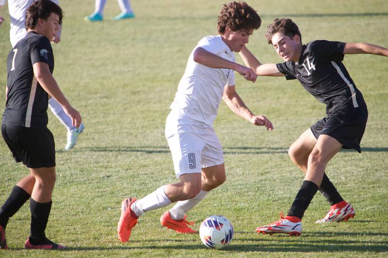 Kaneland's Anthony Buchanan battles for the ball with Sycamore's Javier Lopez at the Class 2A Regional Final on Saturday, Oct. 22,2022 in Sycamore.