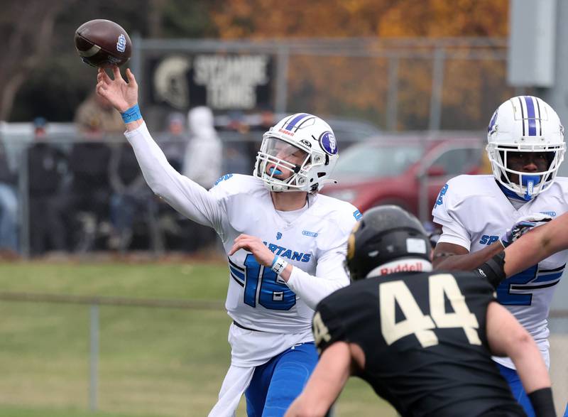 St. Francis' Brady Palmer throws a pass ahead of the pass rush of Sycamore's Cooper Bode Saturday, Nov. 16, 2024, during their Class 5A quarterfinal game at Sycamore High School.