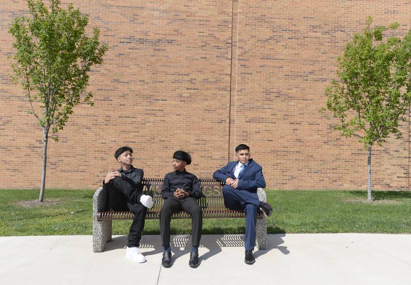 (Left to right) Lavoie Marsh, Rodrigo Diaz and Jesus Flores Perez wait to be picked up outside Downers Grove South High School during the orientation and Mad Dash held Saturday Aug 19, 2023.