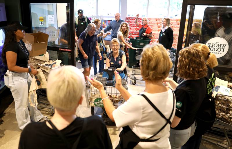 Patricia Baker of St. Charles enters the Whole Foods Market during the grand opening celebration on Wednesday, June 25, 2025 in St. Charles.