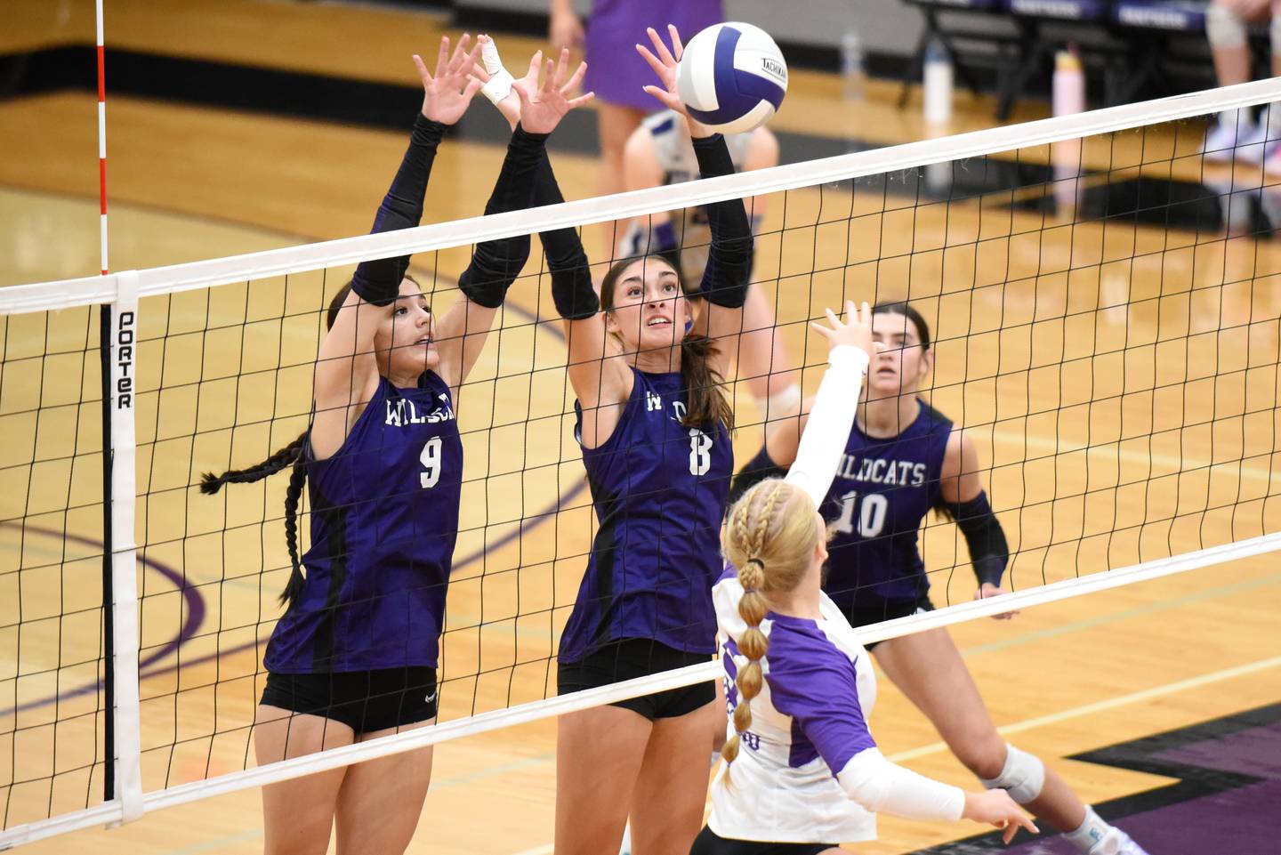 Wilmington's Makenzie Rodriguez, center, and Kate Grosso, left, look to block a hit from Mantneo's Maddy Belisle during a game at Manteno Tuesday, Oct. 7, 2025.