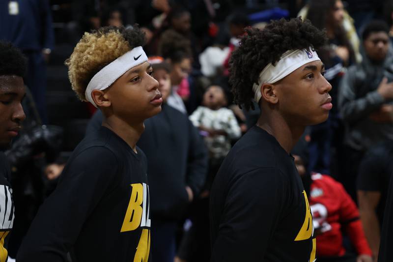 Joliet West’s Jeremiah Fears, left, and his brother Jeremy stand for the National Anthem before the game against Plainfield East.