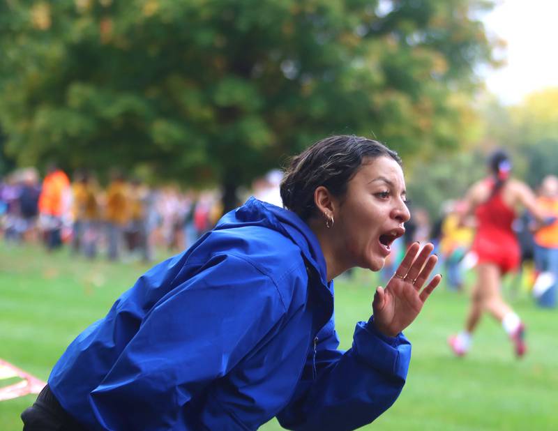 Burlington Central Assistant Coach Nicolette Capetillo offers encouragement for girls runners during the Fox Valley Conference Cross Country Meet at McHenry County College in Crystal Lake on Saturday, October. 18, 2025.