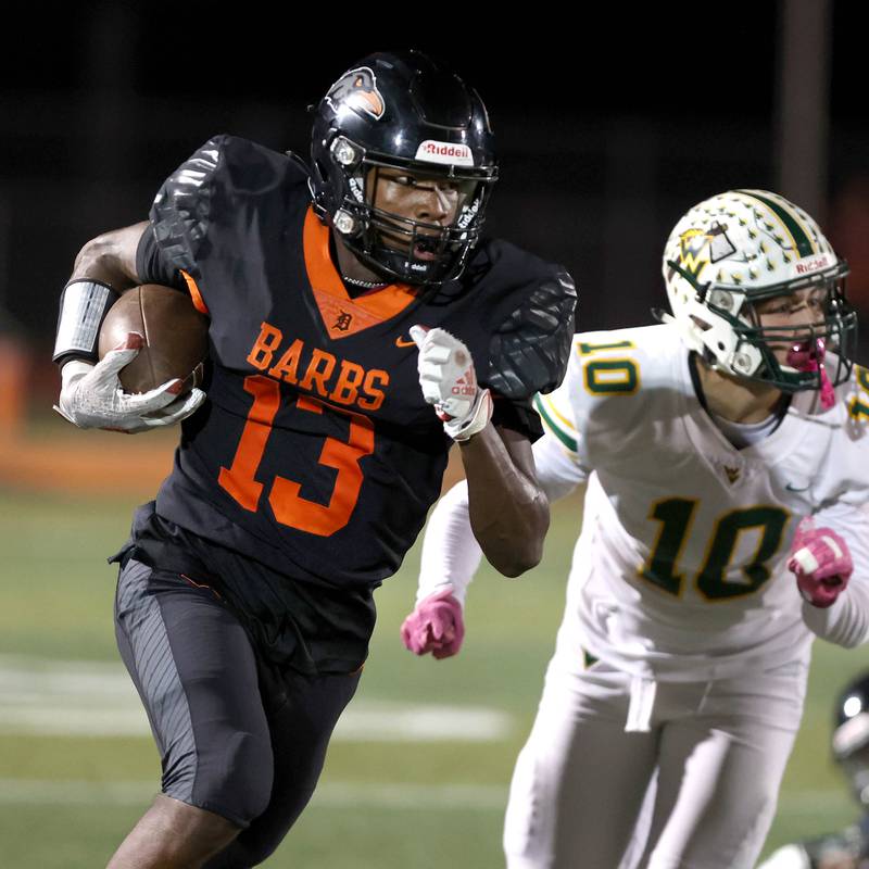 DeKalb’s Davon Grant carries the ball ahead of Waubonsie Valley's Josh Tinney during their game Friday, Sept. 29, 2023, at DeKalb High School.