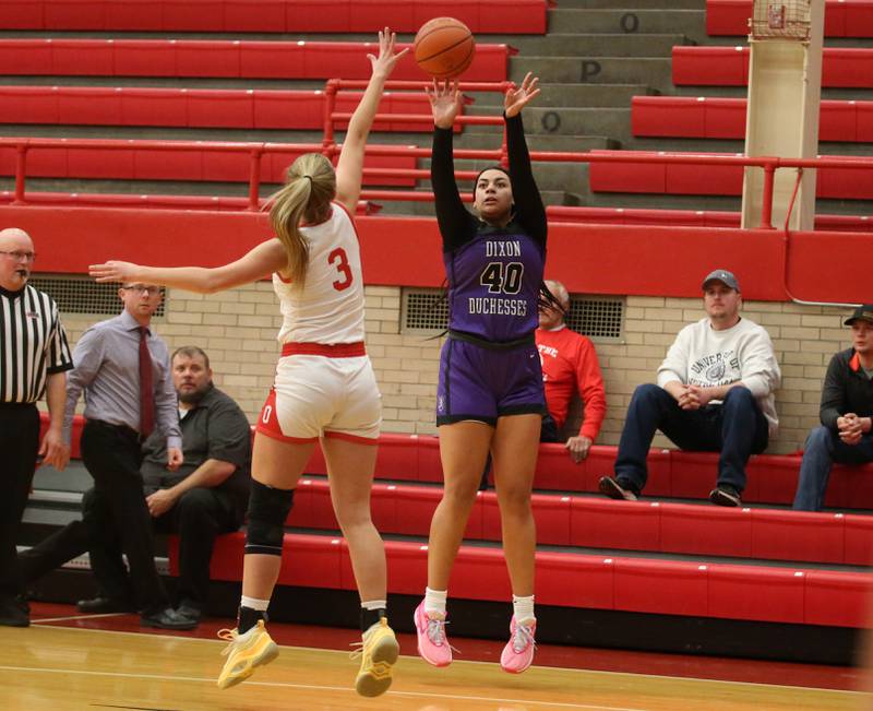 Dixon's Hallie Williamson shoots a three point shot over Ottawa's Skayler Dorsey on Wednesday, Nov. 29, 2023 at Kingman Gym.