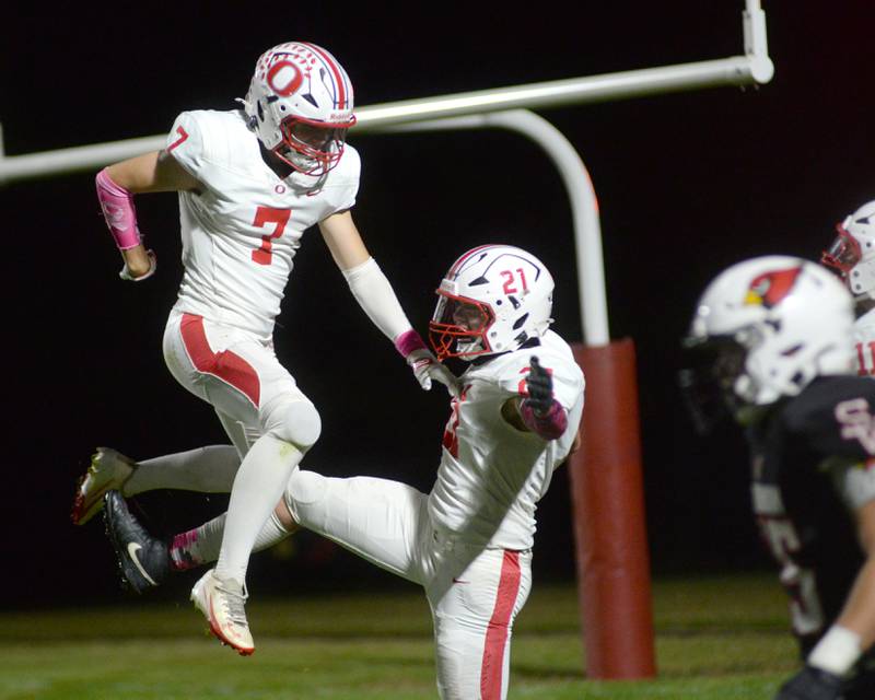 Oregon's  Zandyr Withers (21) celebrates with Ethan Peeking (7) after catching a pass for a touchdown against Stillman Valley on Friday, Oct. 10, 2025.