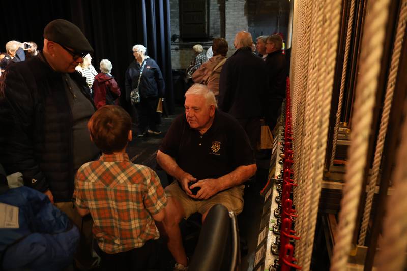 Stagehand Loriin Lynch, whose great uncle Hiram Lynch was the first stage manager at the Rialto Square Theatre, talks with guest at the theater's 100th anniversary celebration on Sunday, May 3, 2026 in Joliet.