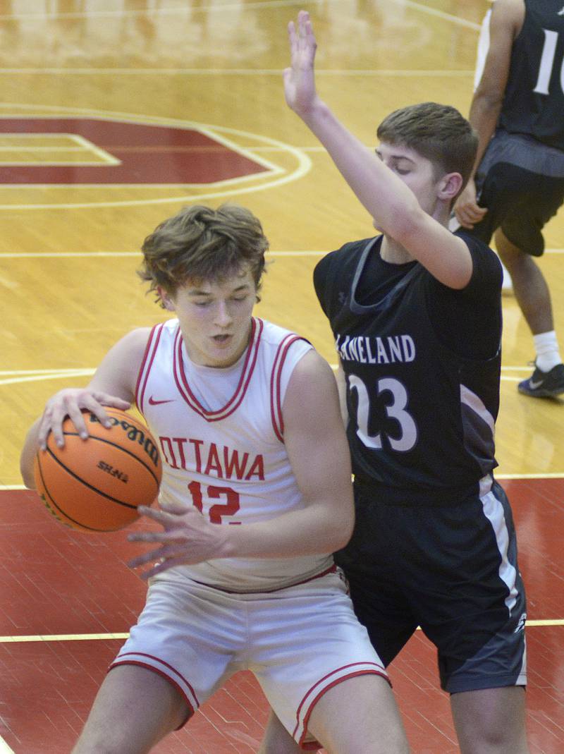 Underneath the basket, Ottawa’s Jack Carrol works to muscle by Kaneland’s Connor Kimme in the 1st quarter Tuesday at Ottawa.