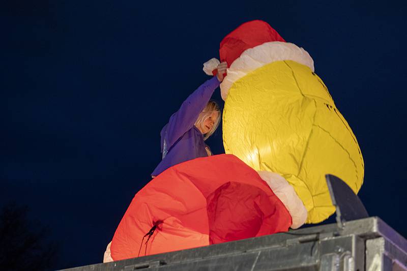Aubrey Boss, 10, of Rock Falls works to straighten up the blow-up Grinch at a holiday display by Boss Roofing on Sunday, Nov. 27, 2022 at Centennial Park in Rock Falls.