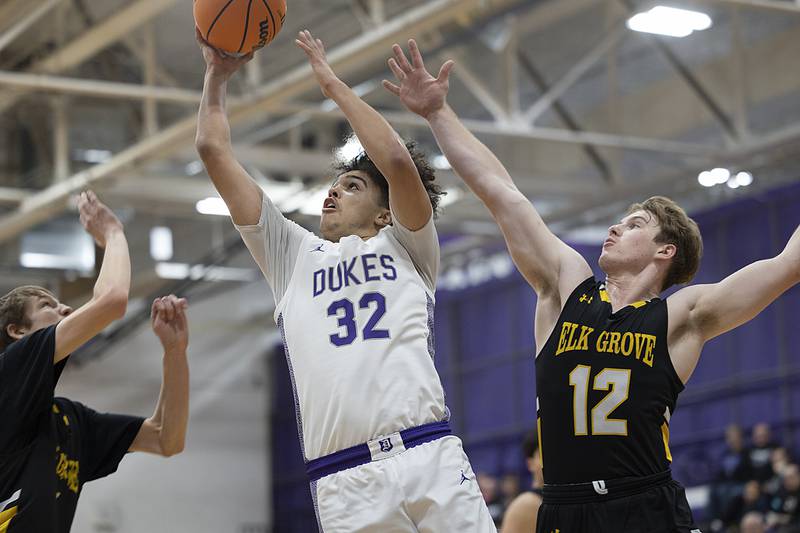 Dixon’s Darius Harrington goes to the hoop against Elk Grove’s Dan Pasterski (right) Saturday, Jan. 11, 2025, at Dixon High School.