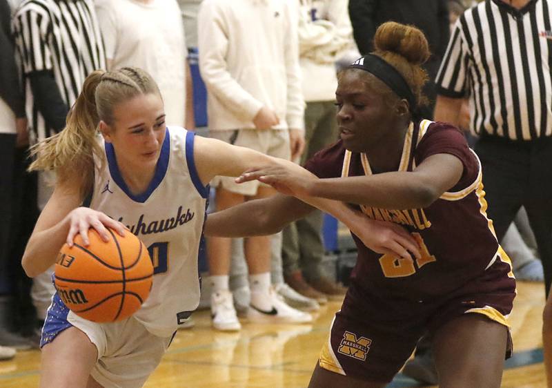 Johnsburg's Maura Oeffling tries to drive the baseline against Chicago Marshall's Alysha Murphy during a IHSA Class 2A Johnsburg Sectional girls basketball semifinal game on Tuesday, February, 24, 2026, at Johnsburg High School.
