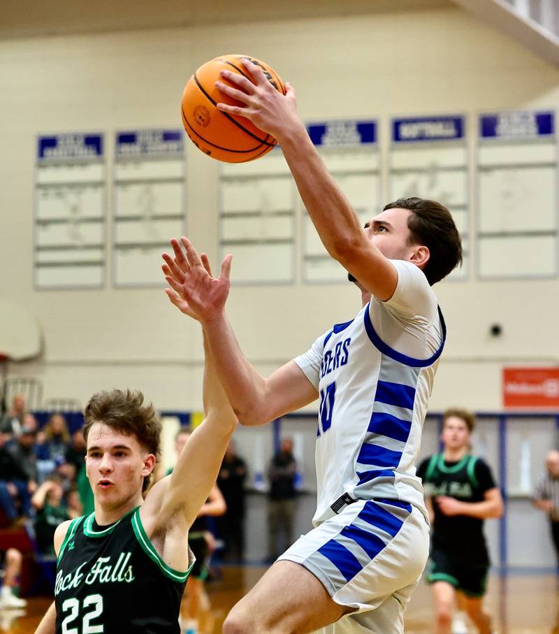 Princeton's Gavin Lanham takes in a layup over Rock Falls' Owen Laws in Tuesday's game at Prouty Gym. The Rockets won 61-58.