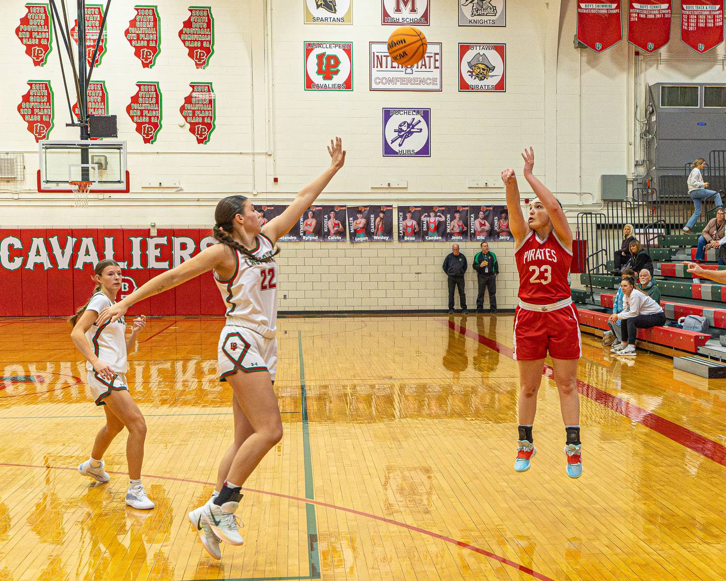 Ottawa's Mary Stisser (23) shoots 3-pointer as Brianna Ruppert (22) of La Salle-Peru closes out in a game this past season at Sellet Gymnasium in La Salle.