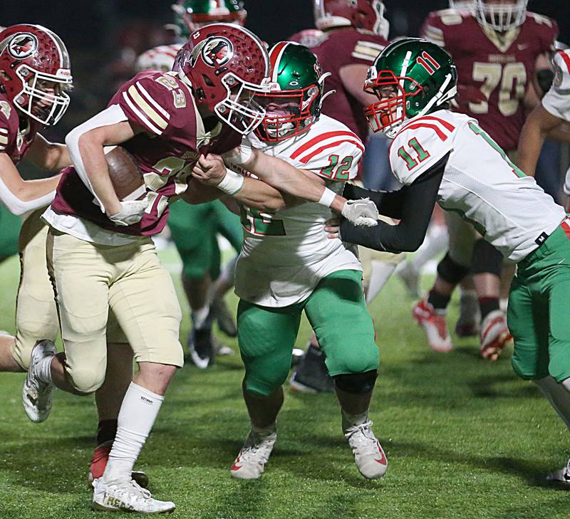 Morris's A.J. Zweeres (23) runs the football as he is brought down by L-P's Antonio Rodriguez (12) and teammate Kaleb Kennedy (11) during the Class 5A round one football game on Friday, Oct. 28, 2022 in Morris.