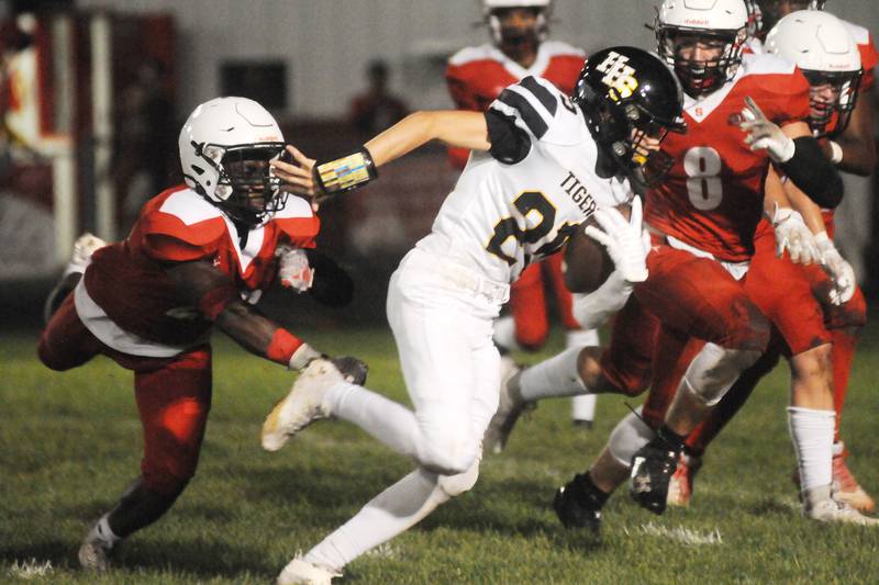 Herscher's Mason Roberts tries to evade the defense of Streator's Tyrese Hendrix and James Pawelczyk (8) at Doug Dieken Stadium on Friday, Sept. 22, 2023.