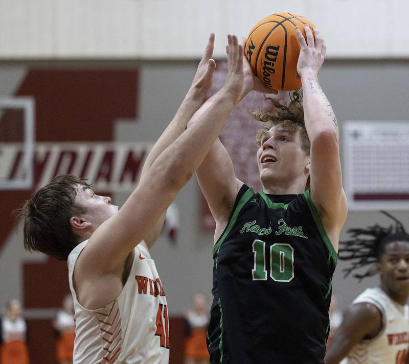 Rock Falls’ Kuitim Heald puts up a shot late in the game over Winnebago’s Brody Larson Tuesday, March 4, 2025, during the 2A boys basketball Sectional final at Marengo.