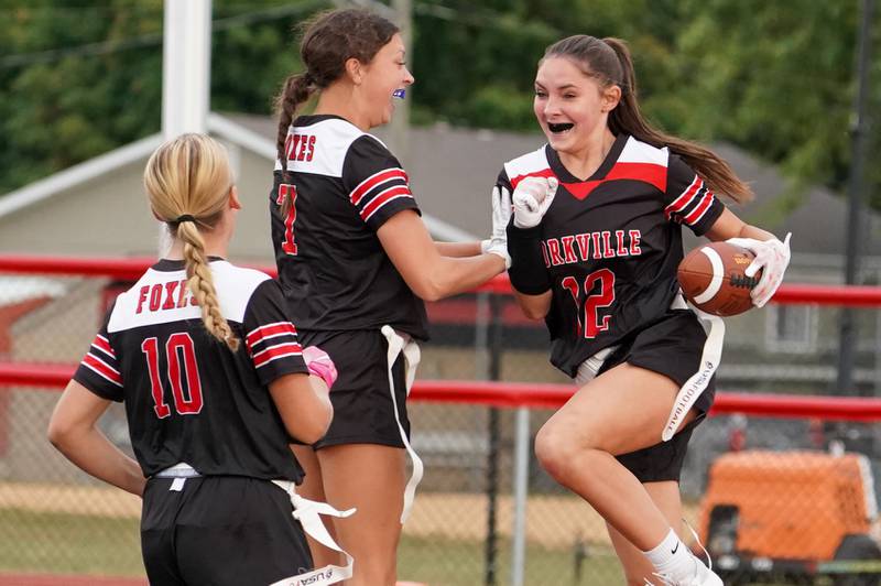 Yorkville's Hayden Hodges (12) smiles after scoring on an interception against Joliet Central during a flag football game at Yorkville High School on Monday, Sep 23, 2024.
