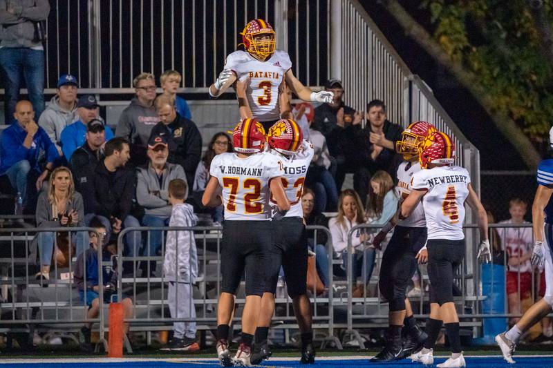 Batavia's Ryan Whitwell (3) is raised in the air by Batavia’s Macquire Moss (63) after Whitewell scores against Geneva during a varsity football game at Geneva High School in Geneva on Friday, Oct 8, 2021.