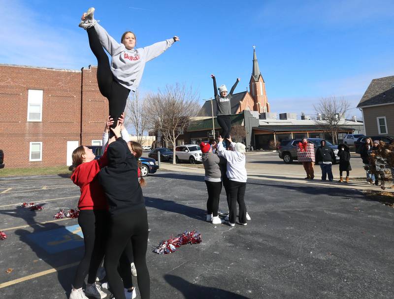 Earlville Jr. High cheerleaders perform a routine during the annual Freezin' for a Reezin' event on Friday, Dec. 6, at the corner of La Salle and Lafayette Street downtown Ottawa. The all-day event to helps the Ottawa Community Food Basket.
