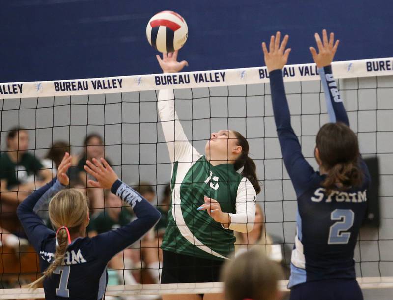 St. Bede's Bella Pinter spikes the ball between Bureau Valley's McKinley Canady and teammate Matalyn Michlig on Tuesday, Sept. 5, 2023 at Bureau Valley High School.