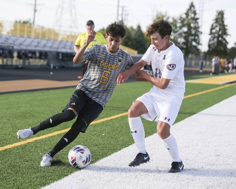 Joliet West's Ronaldo Aguirre (6) battles Plainfield North's Kaden Palmerin (15) along the sidelines during soccer match between Plainfield North at Joliet West. Sept 9, 2025.