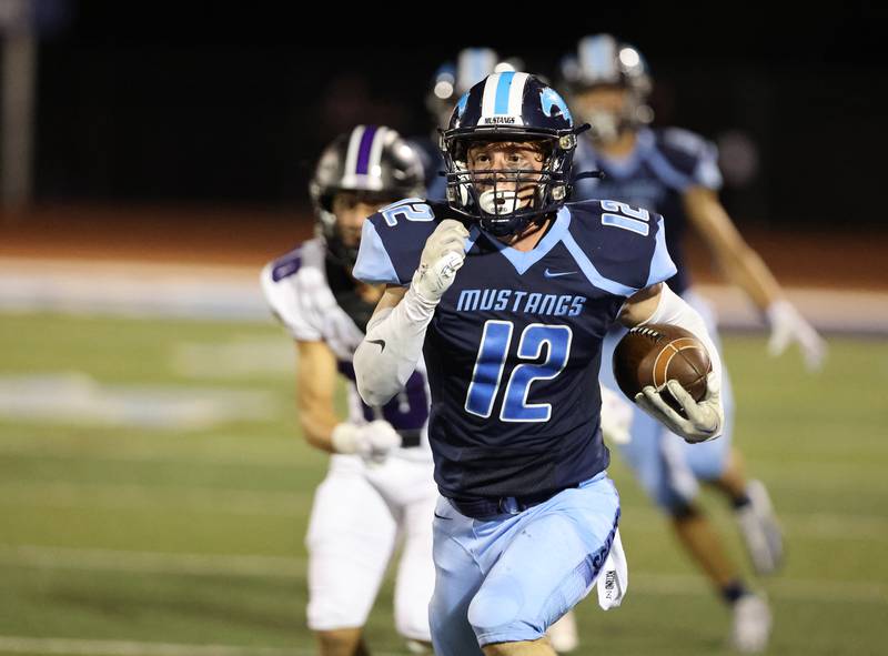 Downers Grove South’s Jack Schoenike (12) runs back an interception during the boys varsity football game on Friday, Sept. 1, 2023.