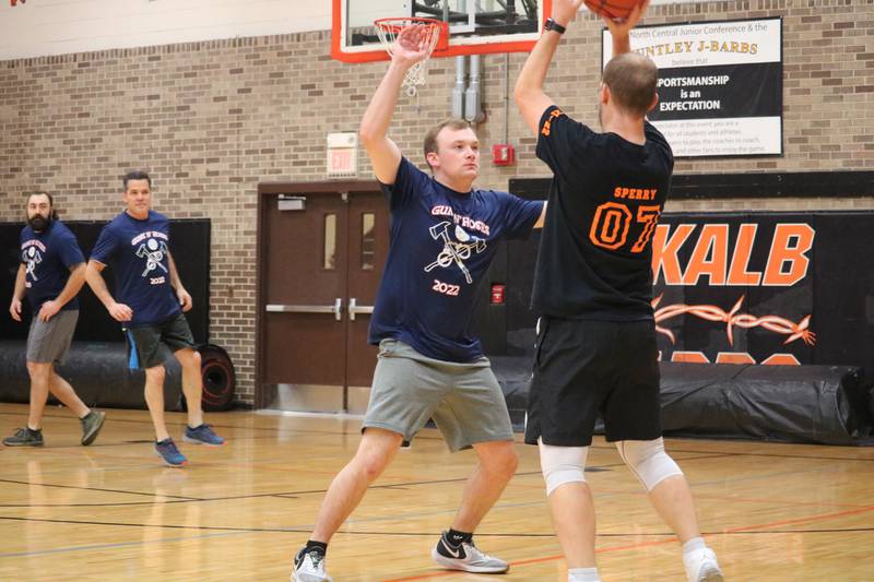Andrew Sperry (right) surveys the floor for an open teammate Monday, Dec. 5, 2022 in the Toys for Tots community basketball game.