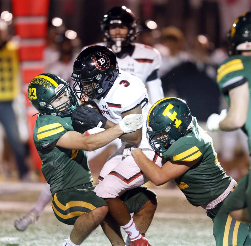 Barrington's Calvin Jackson (3) is wrapped up by a host of Fremd players Friday, Oct. 4, 2024 in Palatine.