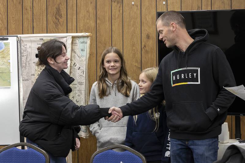 Maddie Carruthers of Cambridge, England meets the Young family, dad Aaron, and daughters Jadah (left), 11, and Ariah, 9, of Morrison Wednesday, Nov. 27, 2024. The family will host the University of Chicago student as part of a Rock River Valley International Fellowship weekend.
