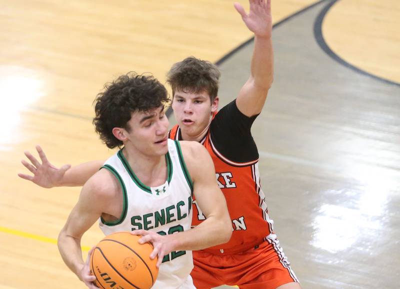 Seneca's Brayden Simek looks to pass the ball around Roanoke Benson's Javin Feucht during the Tri-County Conference Tournament on Tuesday, Jan. 27, 2026 at Putnam County High Schooo.