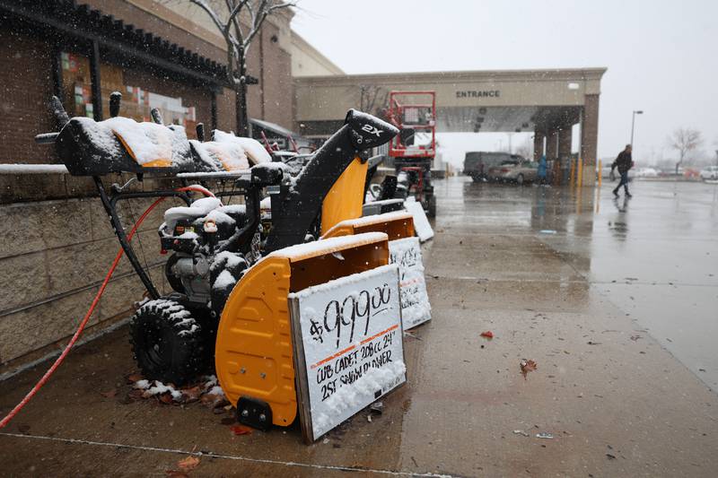 Snow covers snowblowers sitting outside Home Depot in Shorewood on Thursday, Nov. 21, 2024.