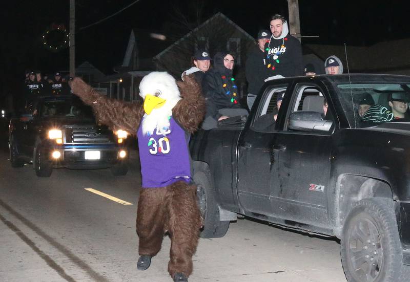 The Illinois Valley Community College baseball team rides a float during the annual Christmas Parade on Saturday, Dec. 7, 2024 on Peoria Street in Peru.