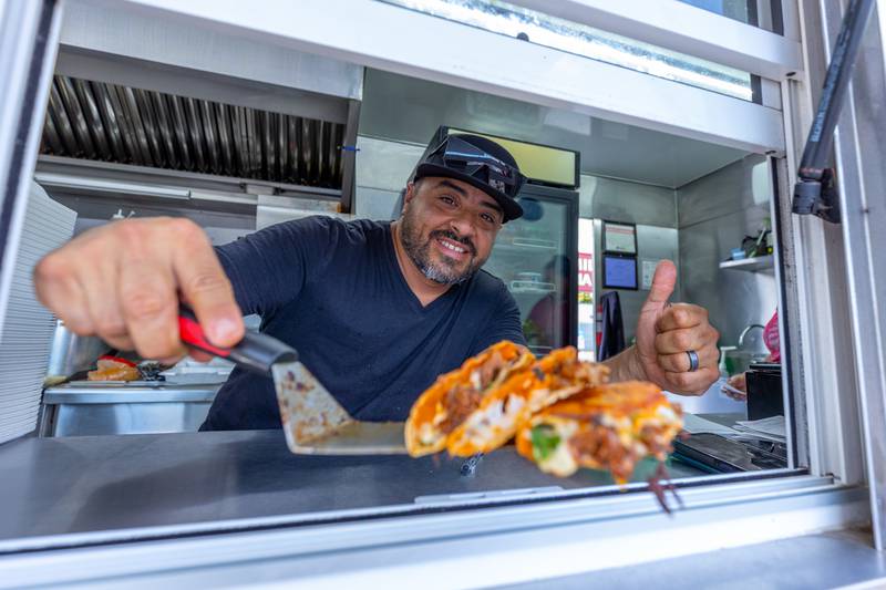 Raul Salinas holds "Quesabirria Tacos" from Salinas food truck on Monday, Aug 25, 2025 on Illinois Avenue in Mendota.