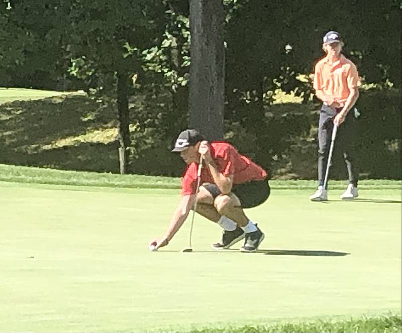 Hall's Grant Plym lines up at putt on hole No. 9 bunker at TPC Deere Run Monday.