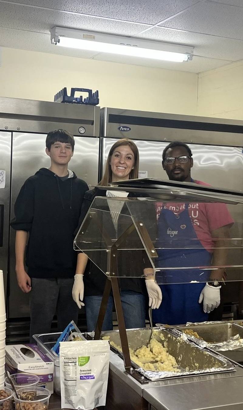 Christopher Day, of Ottawa, Hannah Gilkey, of Sandwich and Jeremiah Cotton, of Ottawa serve Thanksgiving Dinner at A Servants Heart on Wednesday.