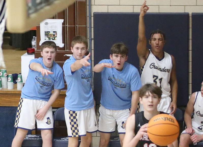 Marquette players react after Earlville's Easton Fruit draws a offensive foul on Friday, Jan. 3, 2025 in Bader Gym at Marquette High School.