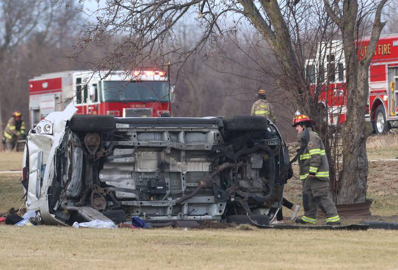 A La Salle firefighter inspects at a vehicle rollover near the entrance to La Sale Speedway on Monday, Jan. 12, 2026 on U.S. Route 6 in La Salle. The crash happened around 8:30a.m. Crews from Utica and La Salle responded to the scene. OSF Lifeflight helicopter landed in the parking lot of La Salle Speedway to transport one patent.