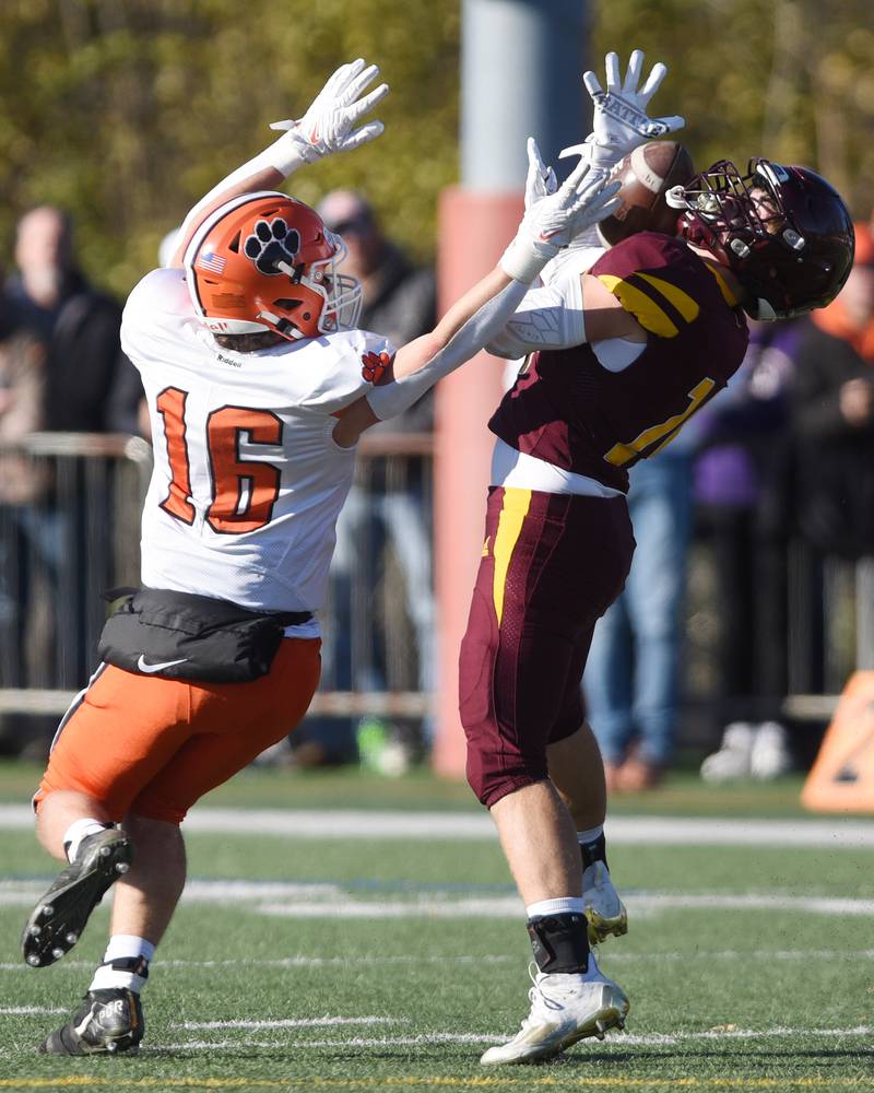 Joe Lewnard/jlewnard@dailyherald.com
Montini's George Asay, right, catches a pass in front of Byron's Andrew Talbert during the Class 3A semifinal game in Lombard Saturday.