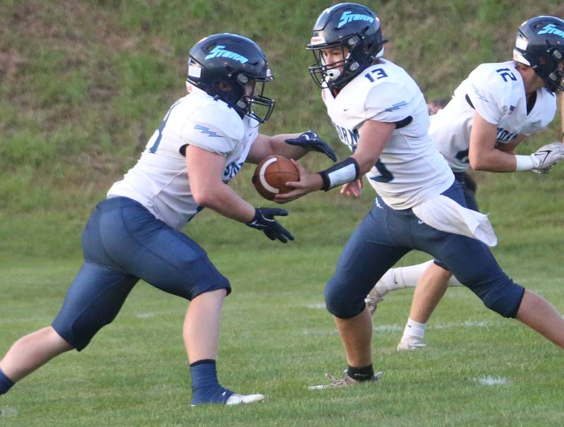 Bureau Valley quarterback Aiden Litherland hands off the ball to teammate William Stewart on Friday Aug. 29, 2025 at St. Bede Academy.